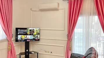 Premium Apartment | Living area | 55-inch Smart TV with cable channels, Netflix, streaming services