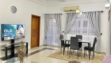 Premium Apartment | Living area | 55-inch Smart TV with cable channels, Netflix, streaming services