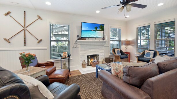 A living room with a fireplace, comfortable seating, and a television. - 450 ft to East Beach • 2 Kings • Pet Friendly • Sleeps 6 • St. Simons Island (Saint Simons Island)