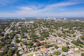 An aerial view of a residential area with houses, streets, and a large body of water in the distance. - Private Heated Salt Water Pool Oasis • 10 Mins to Clearwater Beach (Clearwater)