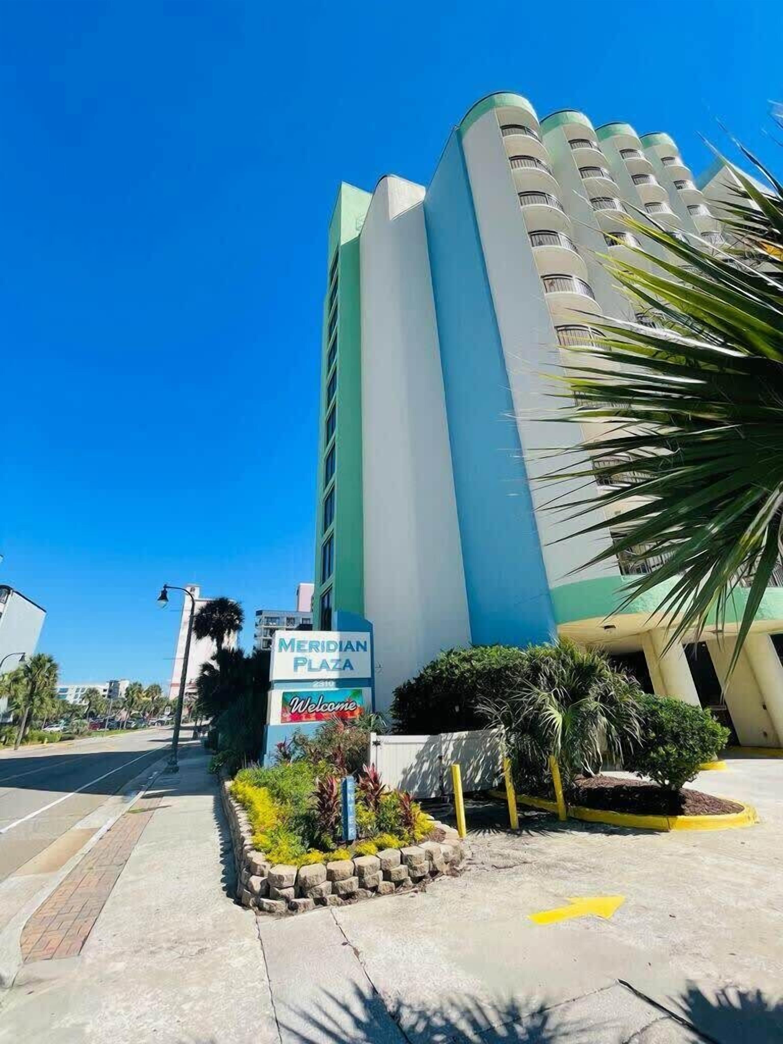 A multi-story hotel with a sign reading "Meridian Plaza".