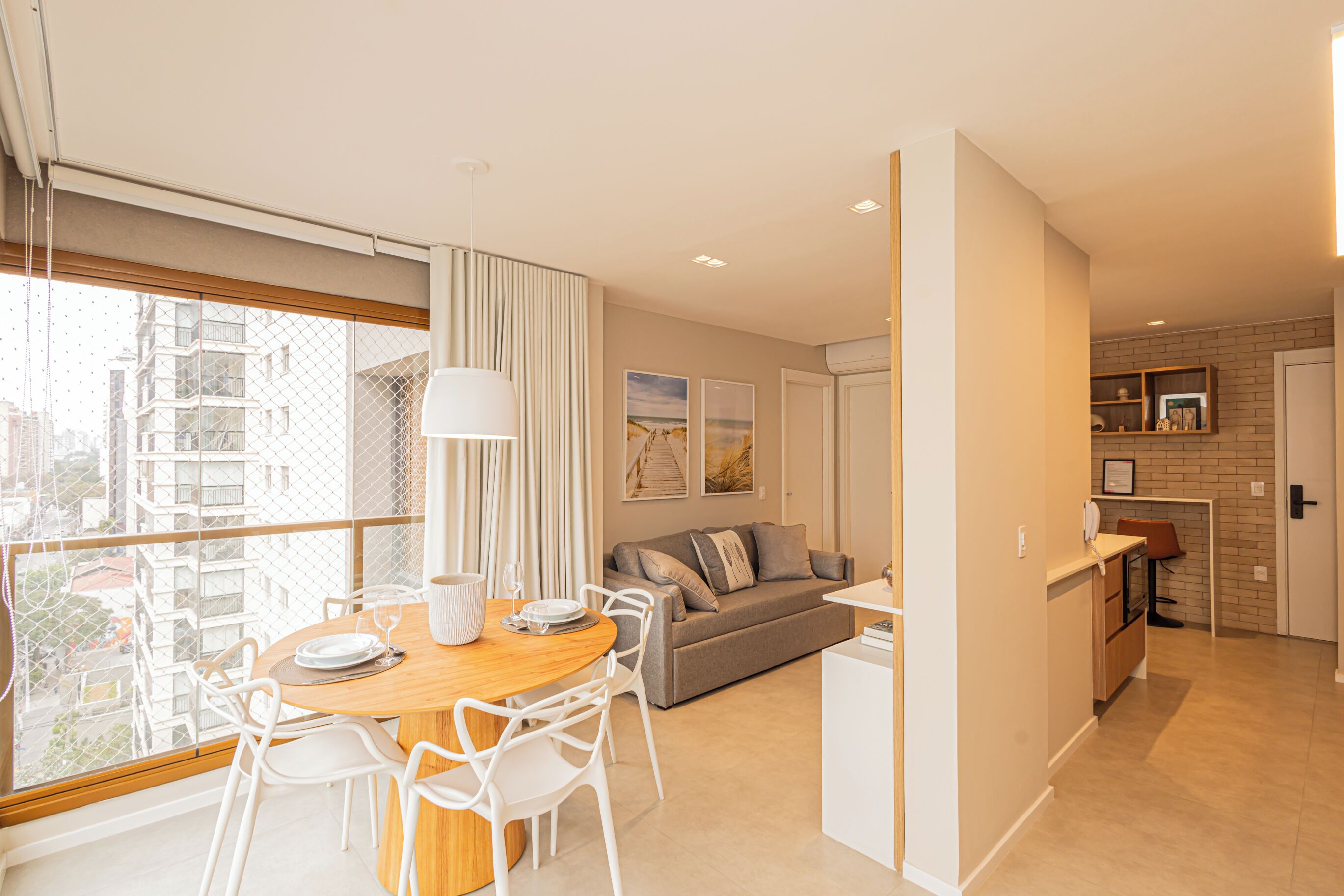 A modern apartment with a dining area, living room, and kitchen.