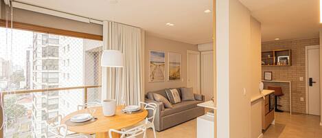 A modern apartment with a dining area, living room, and kitchen.