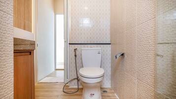 Un baño con inodoro, ducha y lavamanos.