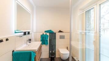Shower, hair dryer, towels, soap