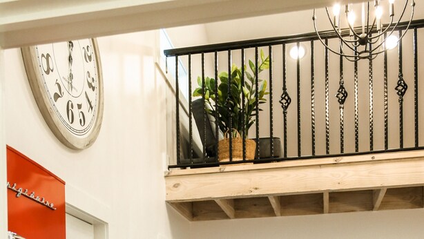 A room with a wooden ceiling, a black chair, a dining table, and a red door. - A fun & happy guesthouse with a loft!  Located 15 min. from Erskine College.  (Honea Path)