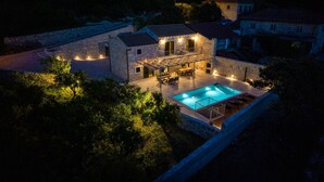 A stone villa with a swimming pool, outdoor seating, and a stone wall surrounding the property. - Amazing home in Gruda (Gruda)