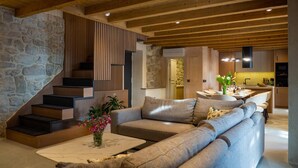 A modern interior with a stone staircase, a sofa set, and a dining area. - Amazing home in Gruda (Gruda)