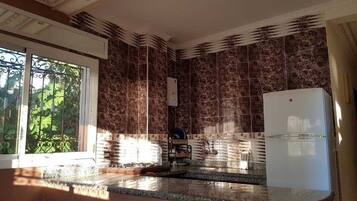 Full-sized fridge, paper towels, dining tables