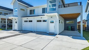 A modern two-story house with a garage, a covered porch, and a well-maintained lawn. - Dog Friendly Townhouse, minutes to MSU & Downtown Bozeman! Welcome Home! (Bozeman)