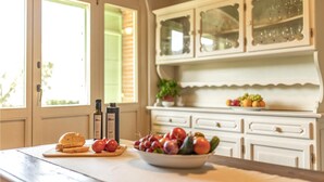A kitchen with a wooden countertop, a bowl of fruit, a loaf of bread, and two bottles of olive oil. - Gorgeous home in Castiglion Fiorentino (Castiglion Fiorentino)