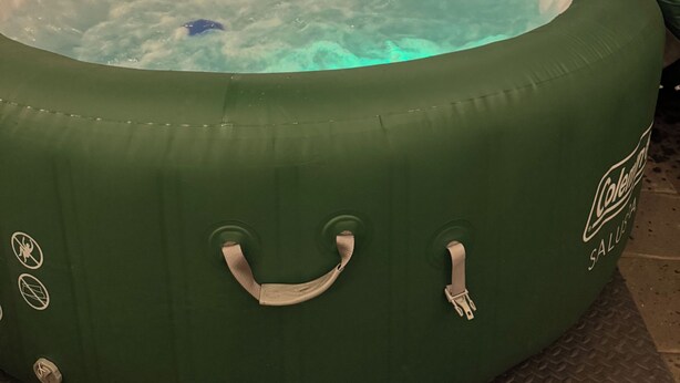 A green inflatable hot tub with handles, surrounded by a wooden fence and string lights. - Charming 1920’s shotgun in southern Indiana, minutes from downtown Louisville  (New Albany)