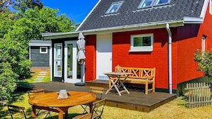 A red house with a grey roof, a wooden deck, and a small garden. - "Anemette" - 100m from the sea by Interhome (Nexø)