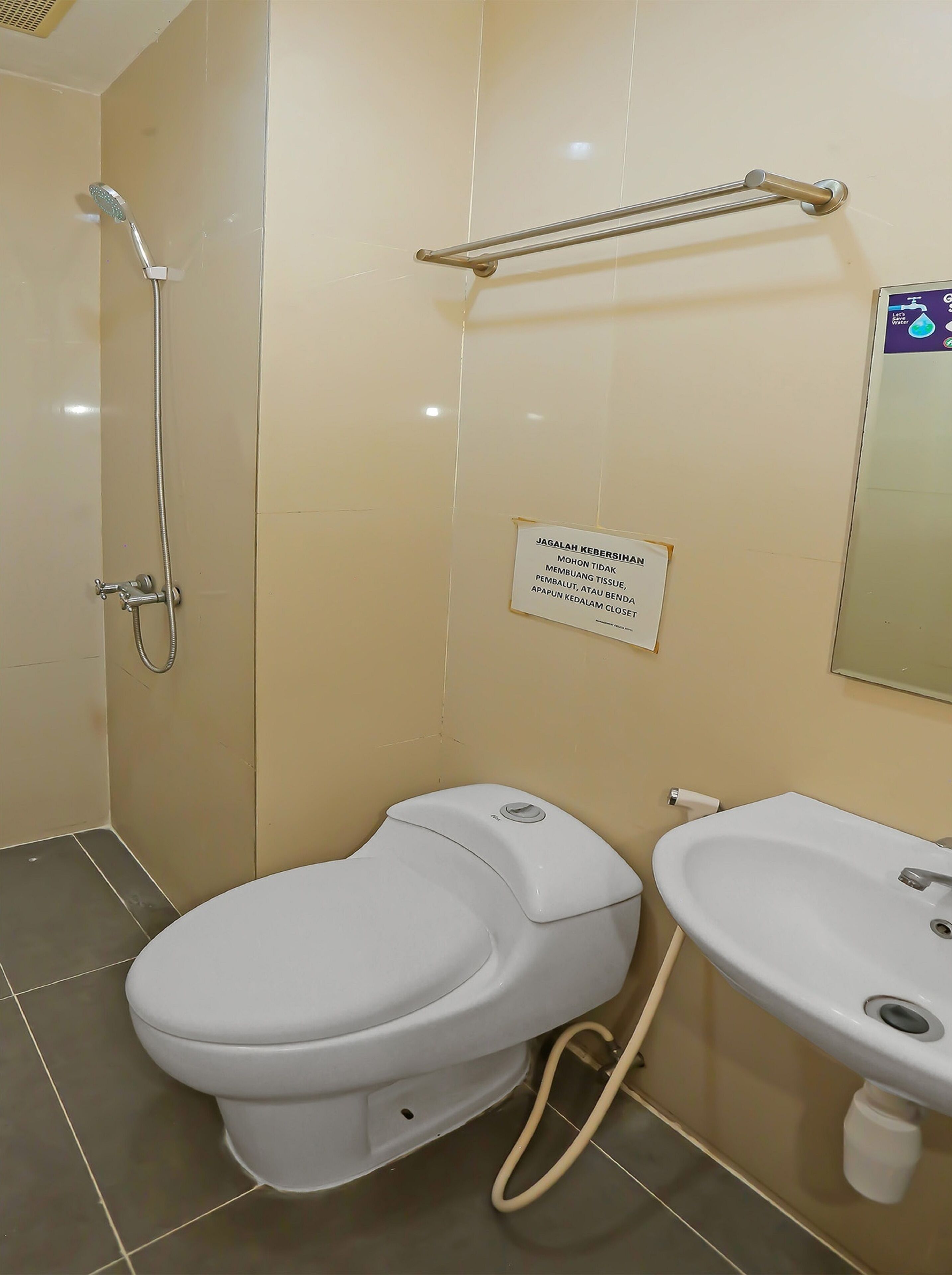 A bathroom with a toilet, a sink, and a shower.