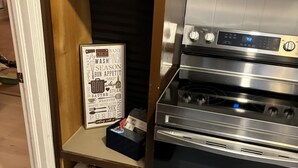 A kitchen with a stainless steel oven and a wooden cabinet above it. - remodeled home-Montgomery,AL: Auburn, Tuskegee. Troy, and ASU -high schools (Montgomery)
