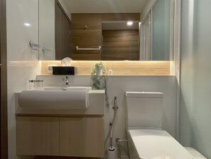 Bathroom features a sink, mirror, towel rack, and a bathtub.