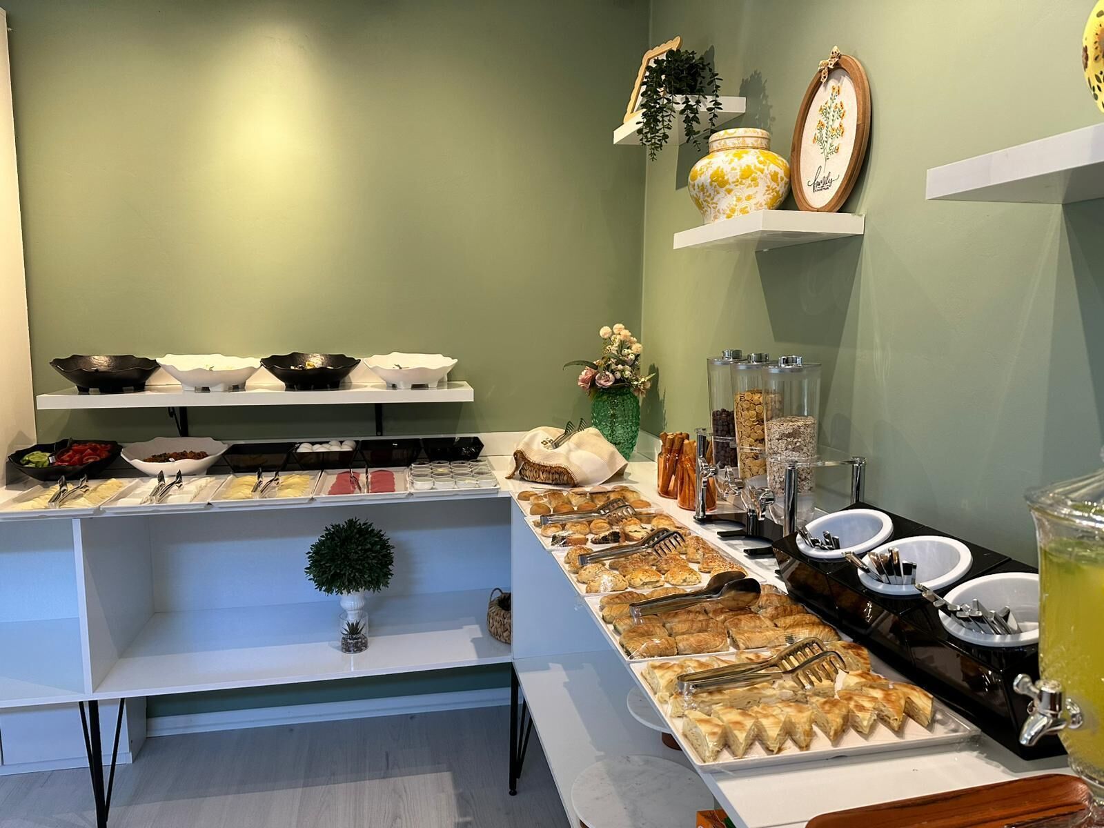 A buffet setup with various food items and utensils.