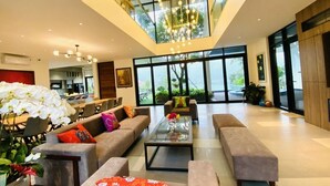 A spacious living area with a high ceiling, large windows, and modern furniture. - TICO VILLA TAM DAO (Tam Dao)