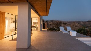 A modern outdoor patio with a view of the countryside. - Modern villa with pool near the Valley of the Temples and the Scala dei Turchi. (Favara)