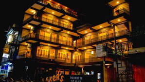 A multi-story building with balconies, illuminated windows, and a sign that reads "Lakers." - Lakers Bed and Breakfast (Pokhara)