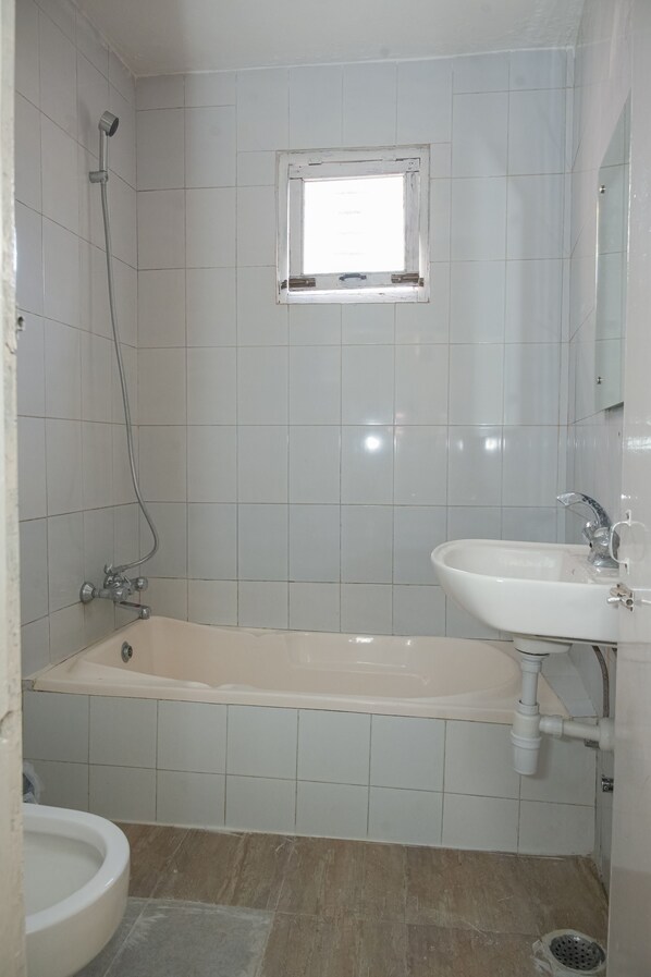 A bathroom with a bathtub, a sink, and a toilet.