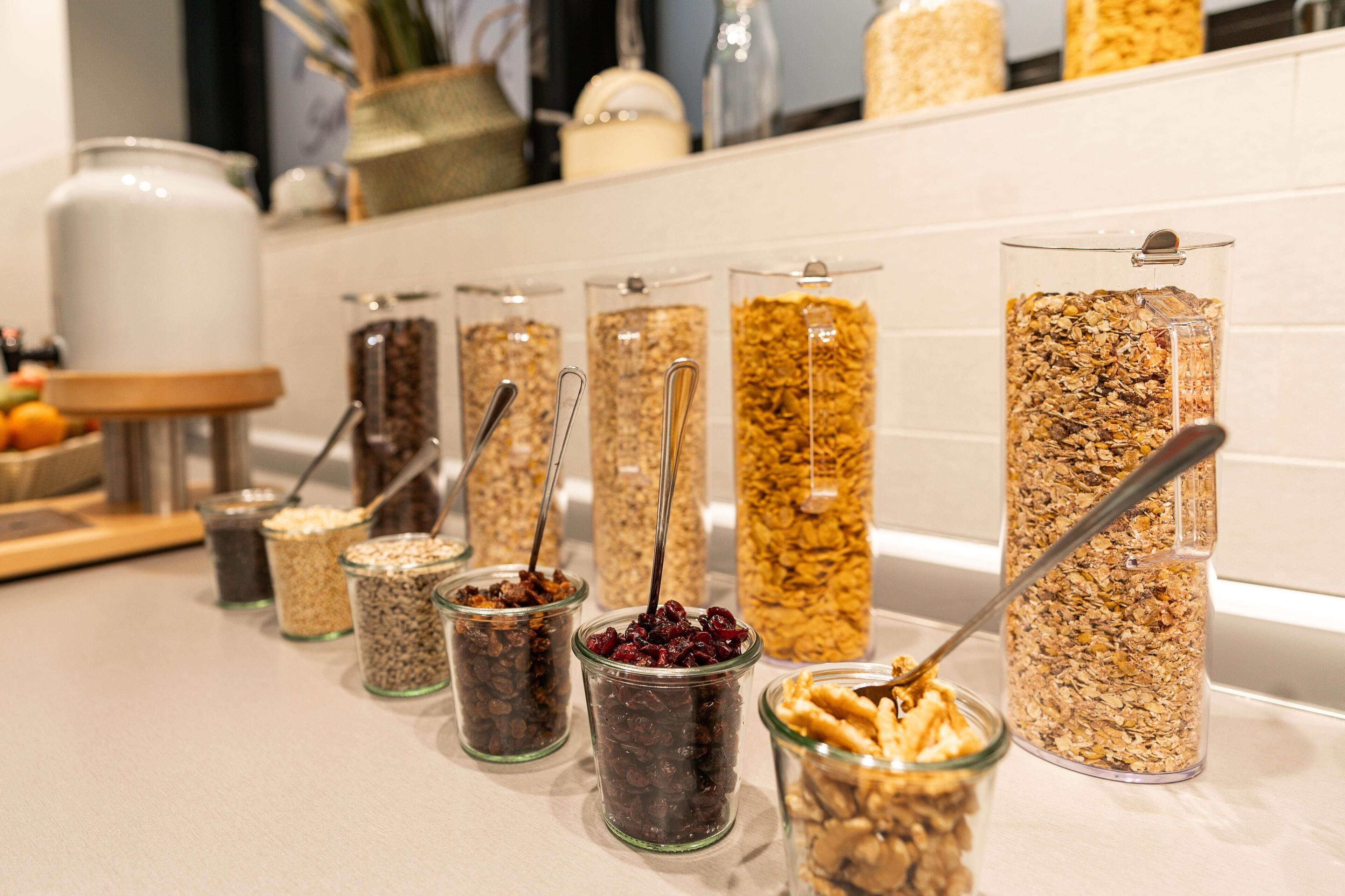 A variety of food items in glass containers on a kitchen counter.