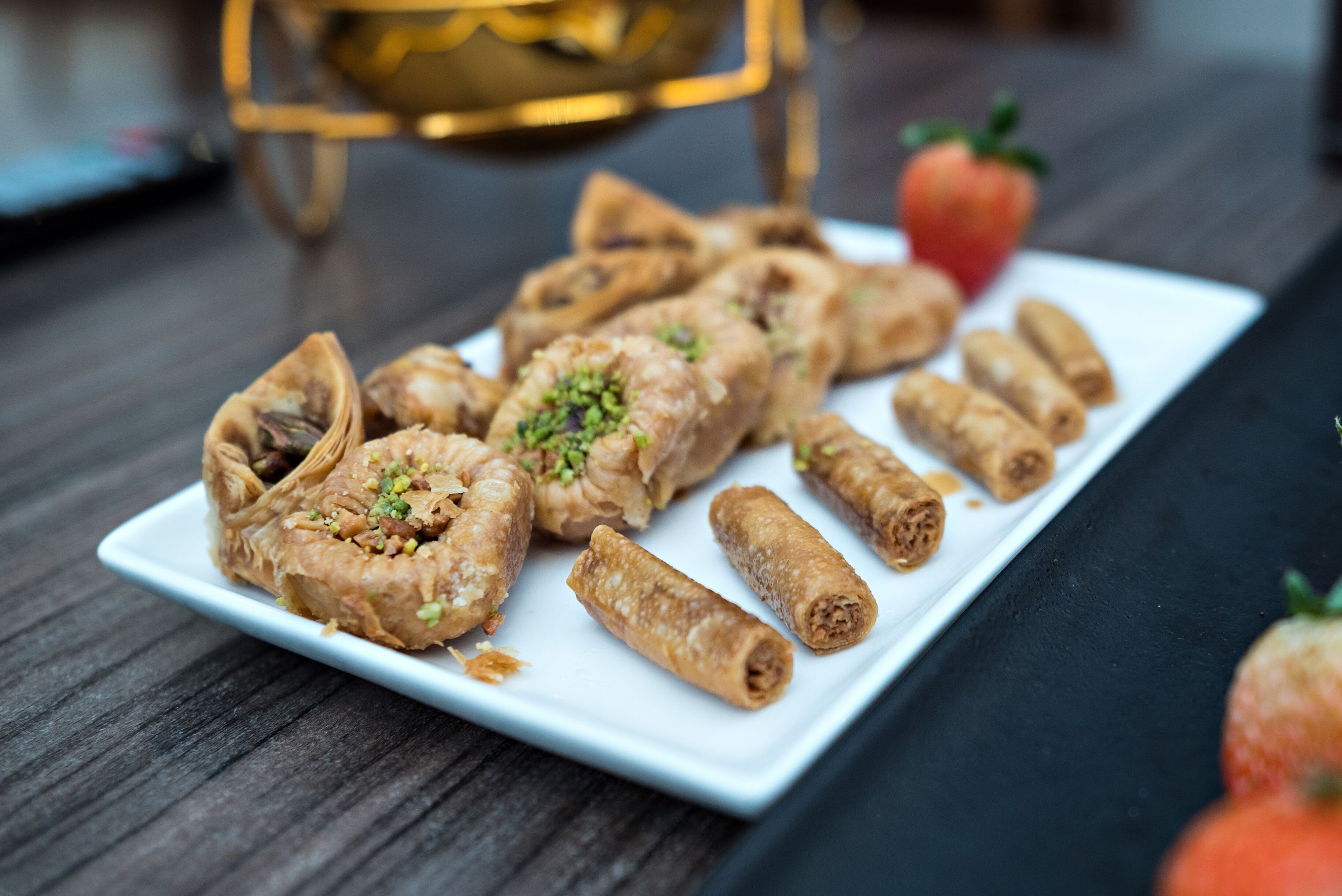 A plate of pastries on a white rectangular plate.