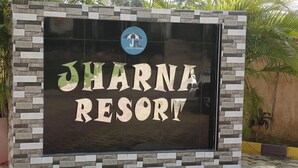 A sign for Jharna Resort with a logo and the resort name in large letters. - JHARNA RESORT (Purulia)