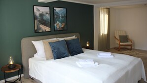 A neatly made bed with white and blue bedding, a wooden side table with a lamp, and two framed pictures on the wall. - Cozy vacation home Zur Alten Burg/Family reunion/Edersee (Vöhl)