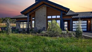 A modern house with a stone facade, large windows, and a sloped roof. - Red Ledges cottage, golf, min 90 day stay (Heber City)
