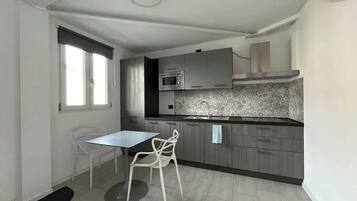 Køleskab, mikrobølgeovn, kogeplade, køkkentøj/tallerkener/redskaber