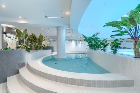 Indoor pool, open 7:00 AM to 10:00 PM, pool loungers, lifeguards on site. MARGI Smart Apartment