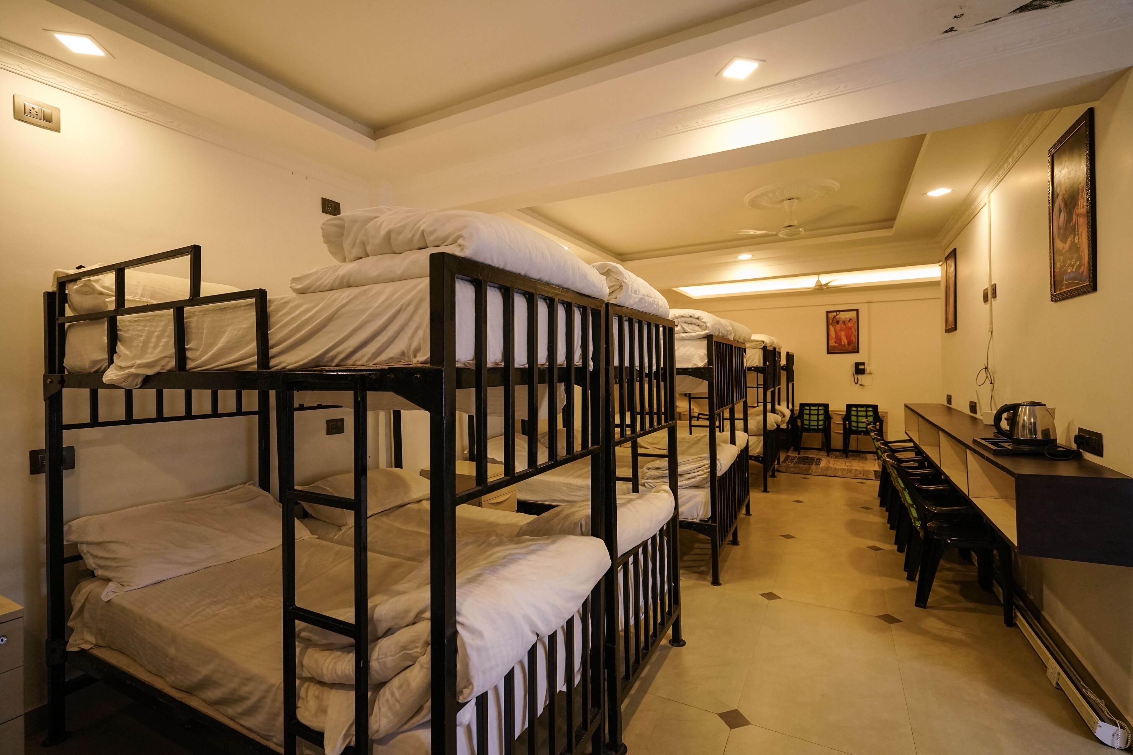A bunk bed room with a kitchenette area, including a stove and sink.