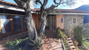 A stone building with a tiled roof, a wooden door, and a small window. - Detached Holiday Home on Olive Grove with Beautiful Sea View (Liguria)