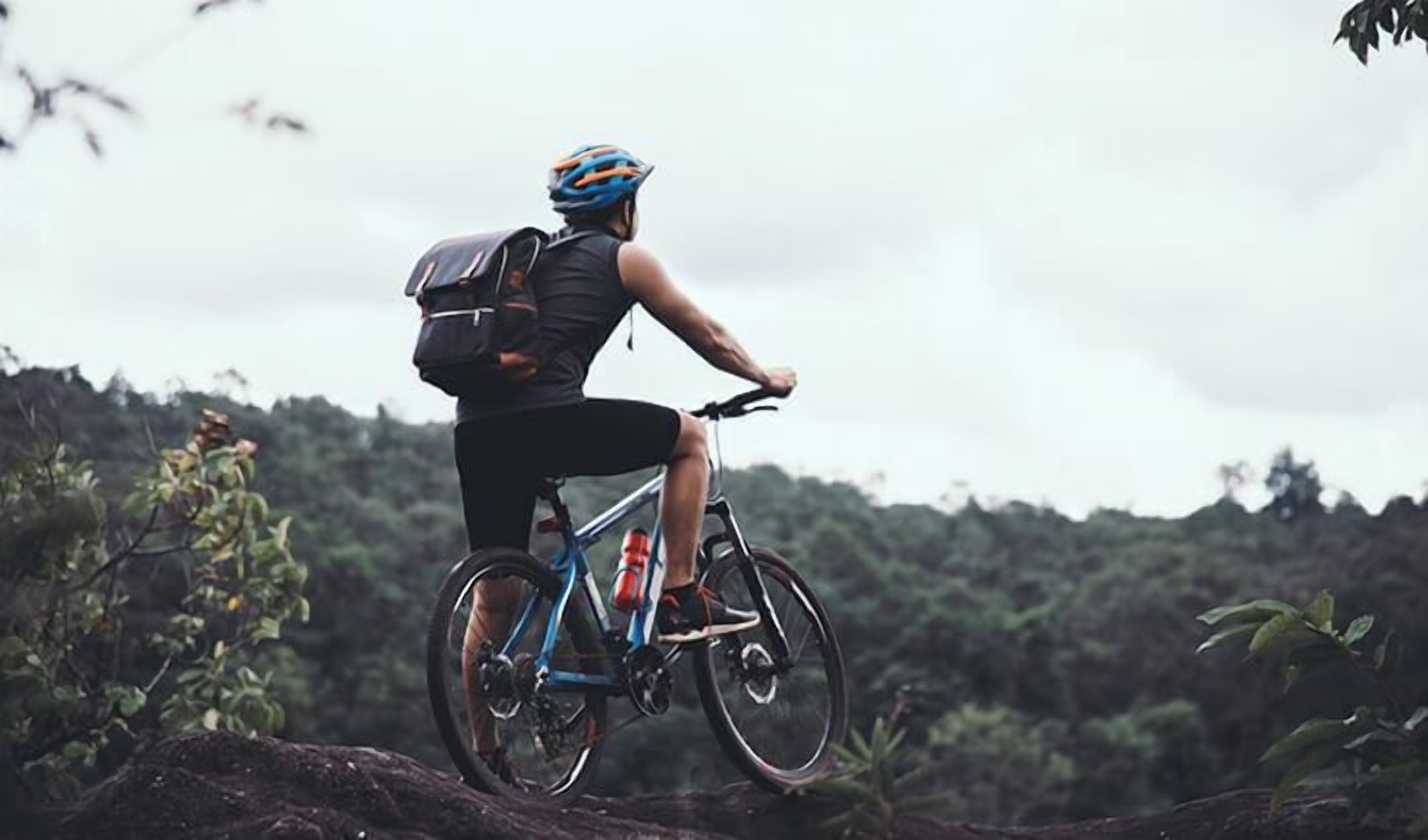 A person riding a mountain bike in a natural setting.