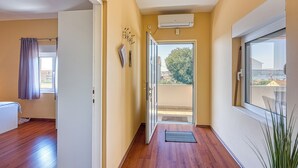 A hallway with wooden flooring, a white door, and a view of the outside. - Coastal Paradise Villa With Pool (Sveti Filip i Jakov)