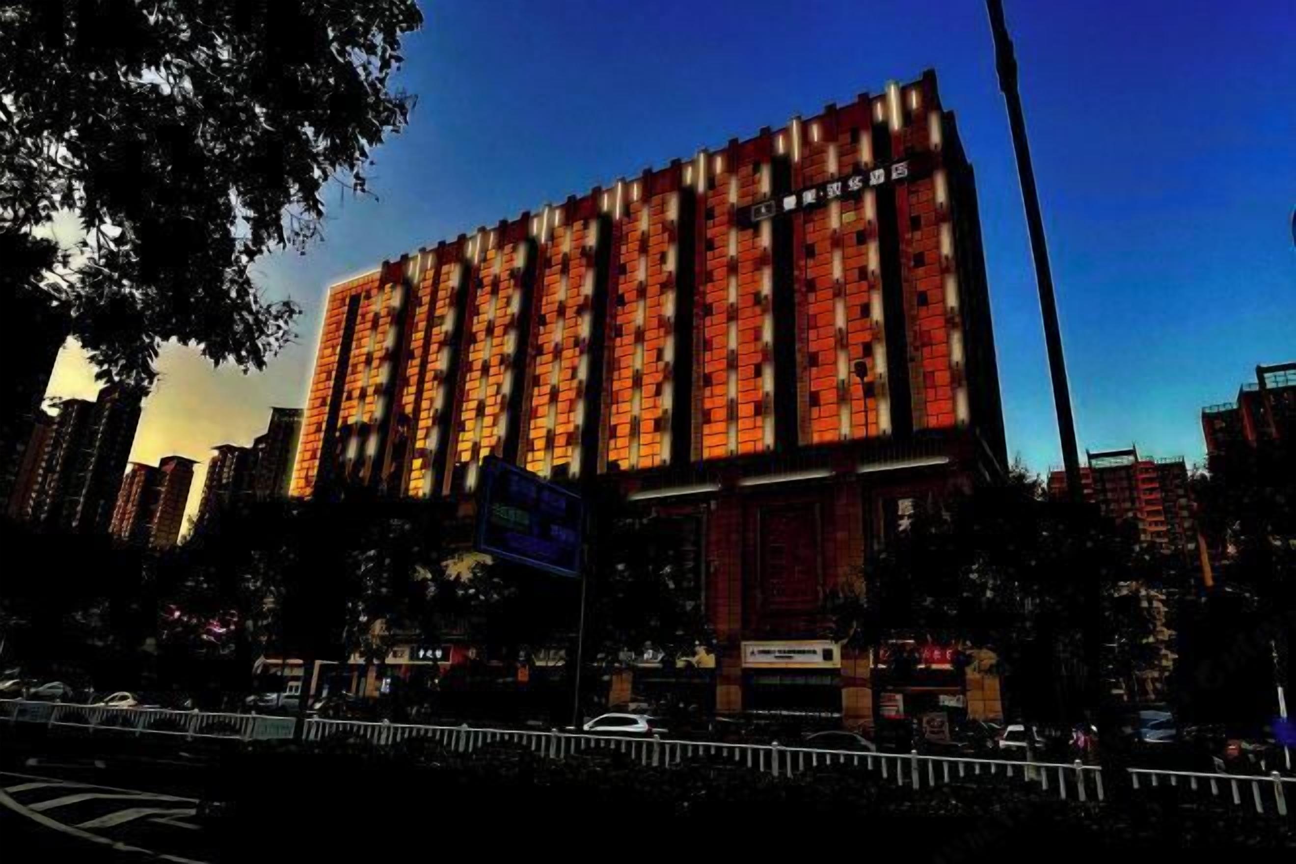 A multi-story building with a brick facade and large windows.