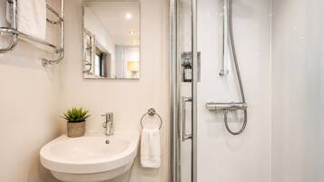 Shower, hair dryer, towels, toilet paper
