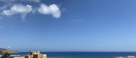 A coastal town with traditional buildings and a clear view of the sea.