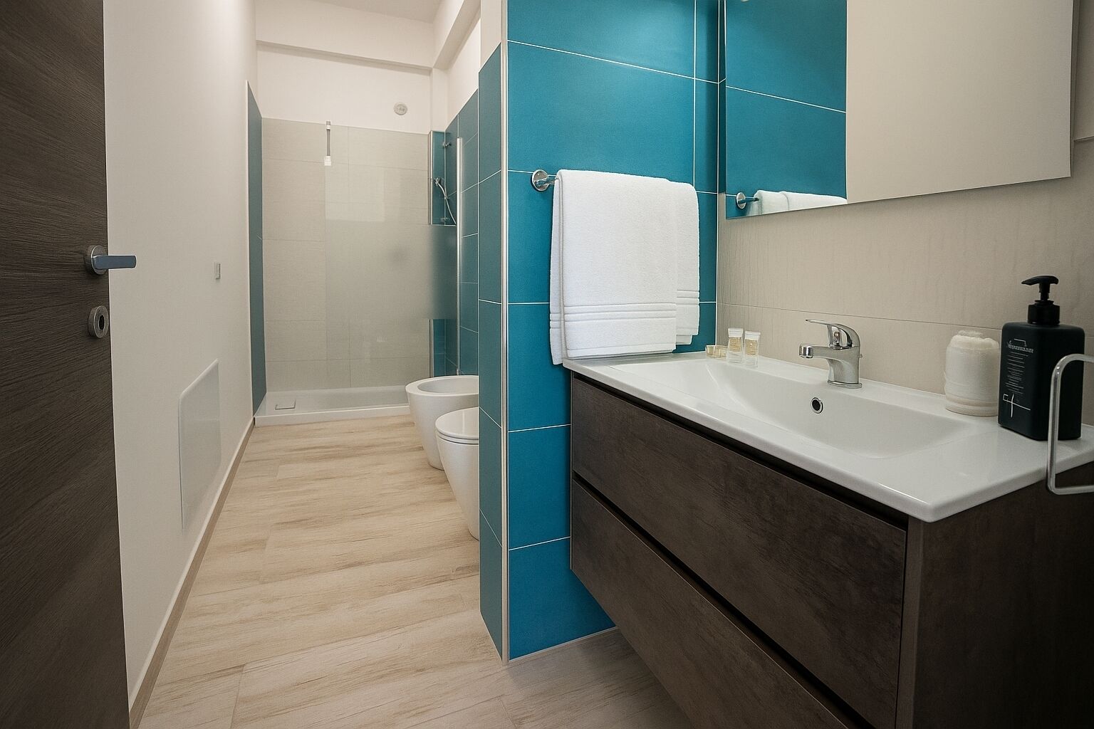 A modern bathroom with a shower, toilet, and sink.
