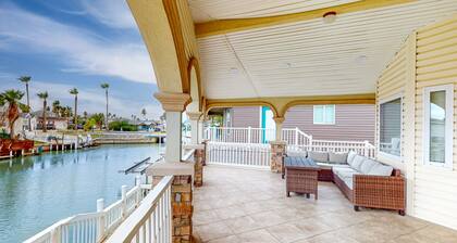Single-level waterfront retreat with a furnished patio, AC, & washer/dryer