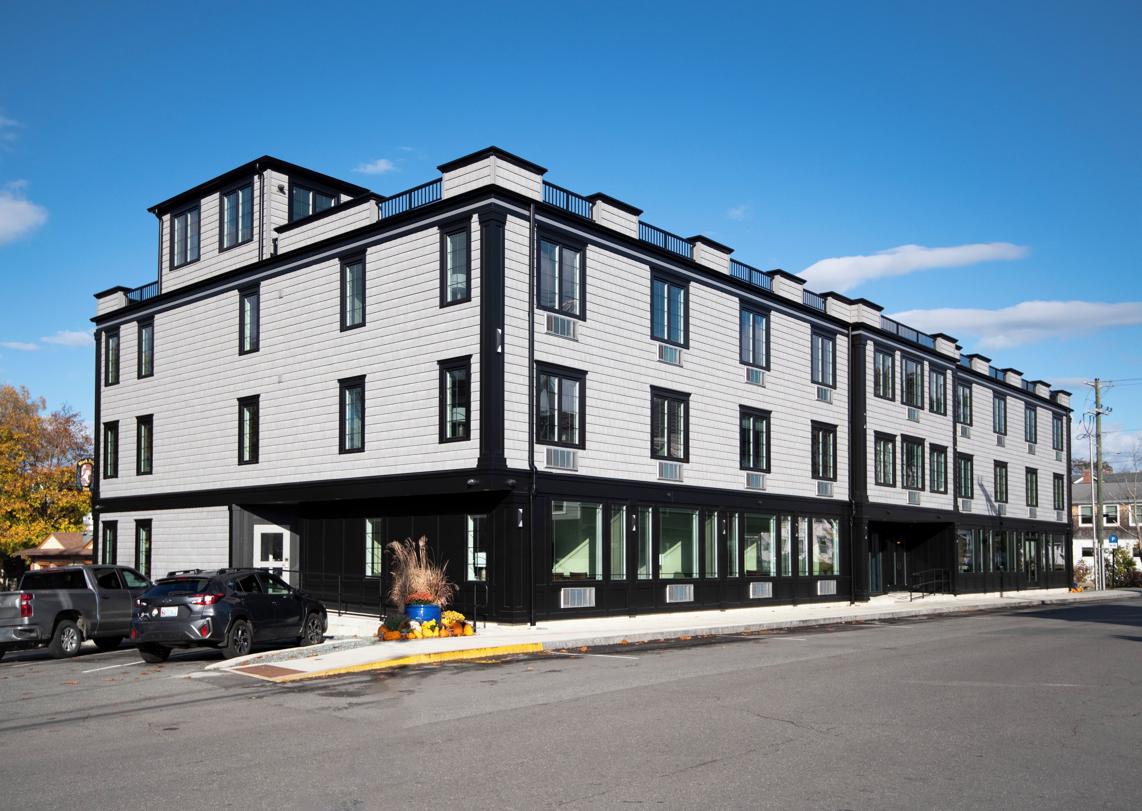 A modern multi-story building with large windows and a flat roof.