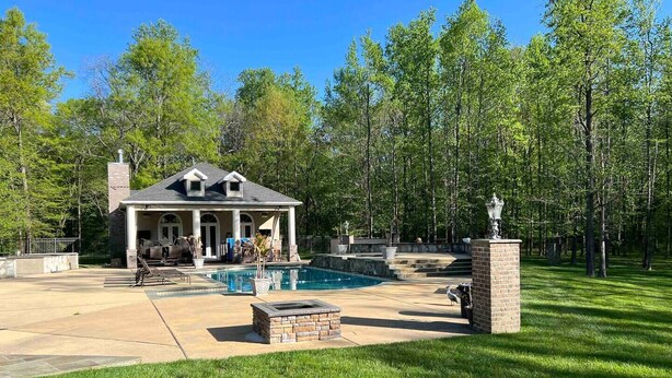 A house with a pool, patio furniture, and a well-maintained lawn. - 25+ walk friendly acres (Upper Marlboro)