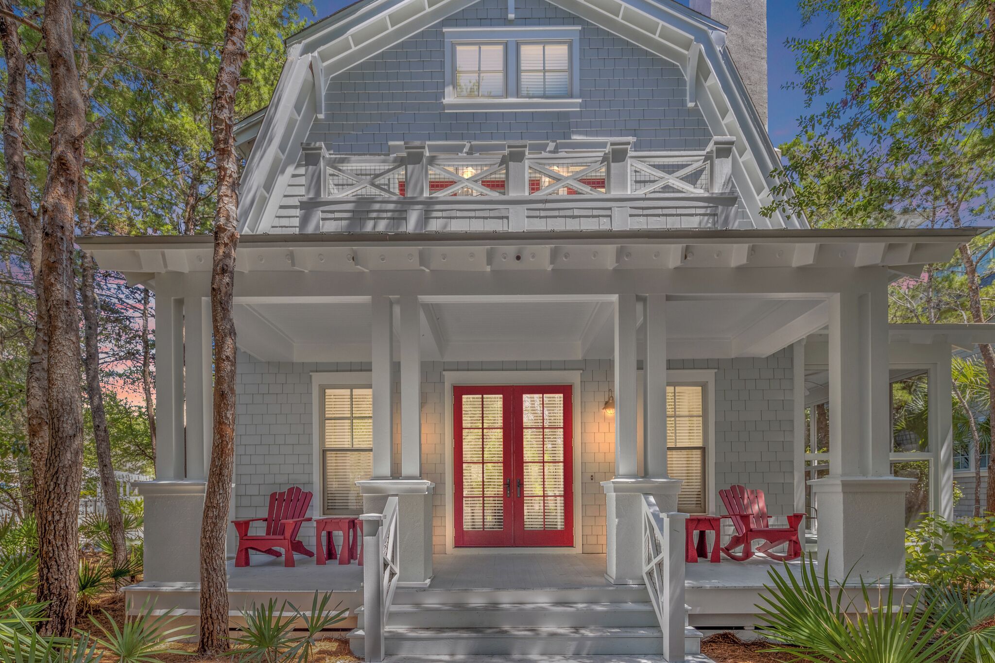 A house with a porch, red door, and white columns.