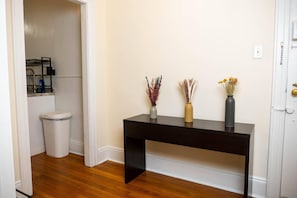 Cozy retreat with a console table, vases, and a shelf for essentials.