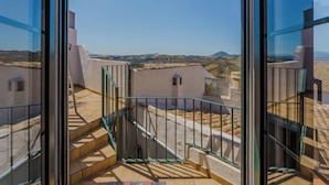 A view from a balcony with a clear sky and distant hills. - Casa del Patito with Vista | Duckling Stays (Olvera)