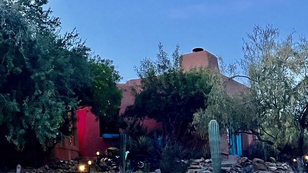 A desert garden with cacti, a stone staircase, and a building with a red door. - Charming Adobe Casita! Large lot in upscale quiet neighborhood. STR 15734641 (Fountain Hills)