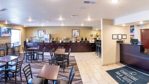 A hotel lobby with a reception desk, seating area, and a kitchenette. - Cobblestone Inn & Suites - Winters (Winters)