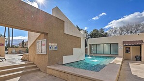 A pool area with steps leading to a door, a sign indicating no lifeguard on duty, and a clear blue sky. - Tranquil & bright loft-style townhouse near Sabino Canyon!   (Tucson)