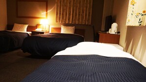 A hotel room with two beds, a nightstand with a lamp, and a television. - HOTEL THE NEXT KANKU (Sennan)